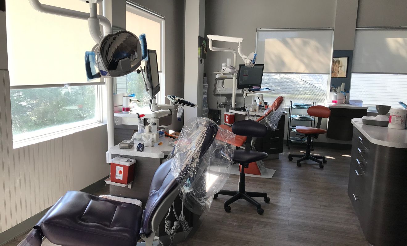 Sunlit orthodontic treatment room with large windows